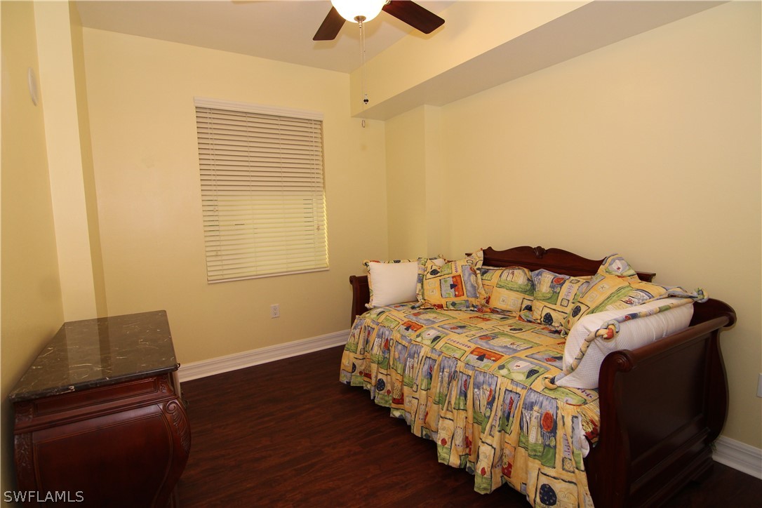 2797 First Street, Unit 804 Fort Myers, FL 33916 - Photo 29 of 34 a bedroom with a bed and wooden floor