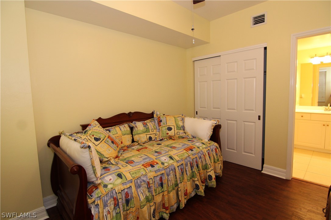 2797 First Street, Unit 804 Fort Myers, FL 33916 - Photo 30 of 34 a bedroom with a bed and wooden floor
