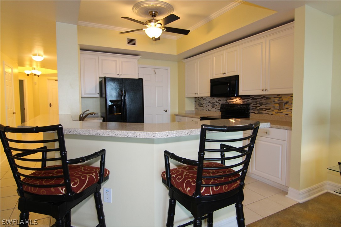 2797 First Street, Unit 804 Fort Myers, FL 33916 - Photo 8 of 34 a living room with furniture a flat screen tv and kitchen view