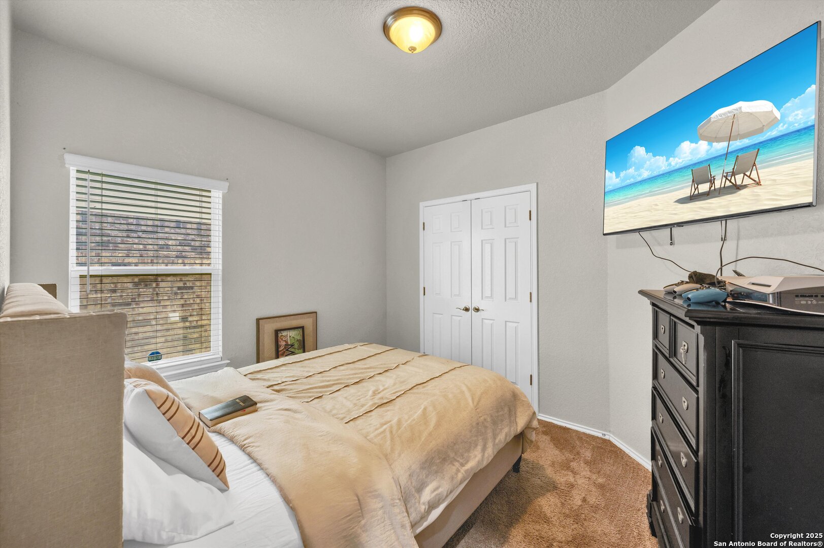 7235 Lunar Eclipse Converse, TX 78109 - Photo 20 of 29 a bedroom with a bed and a flat tv screen on dresser