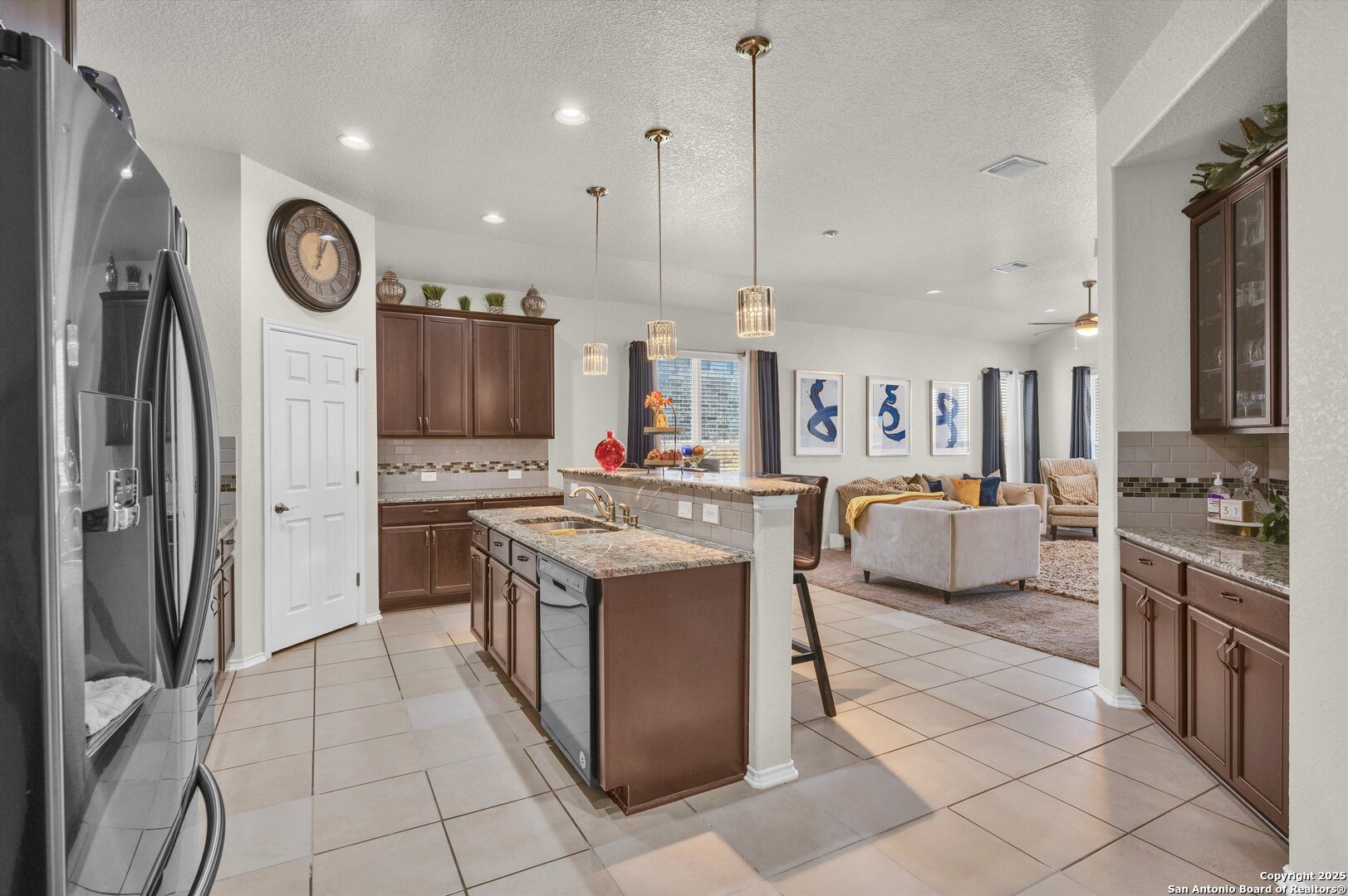 7235 Lunar Eclipse Converse, TX 78109 - Photo 6 of 29 a large kitchen with stainless steel appliances kitchen island granite countertop a stove a sink dishwasher and a refrigerator with wooden floor