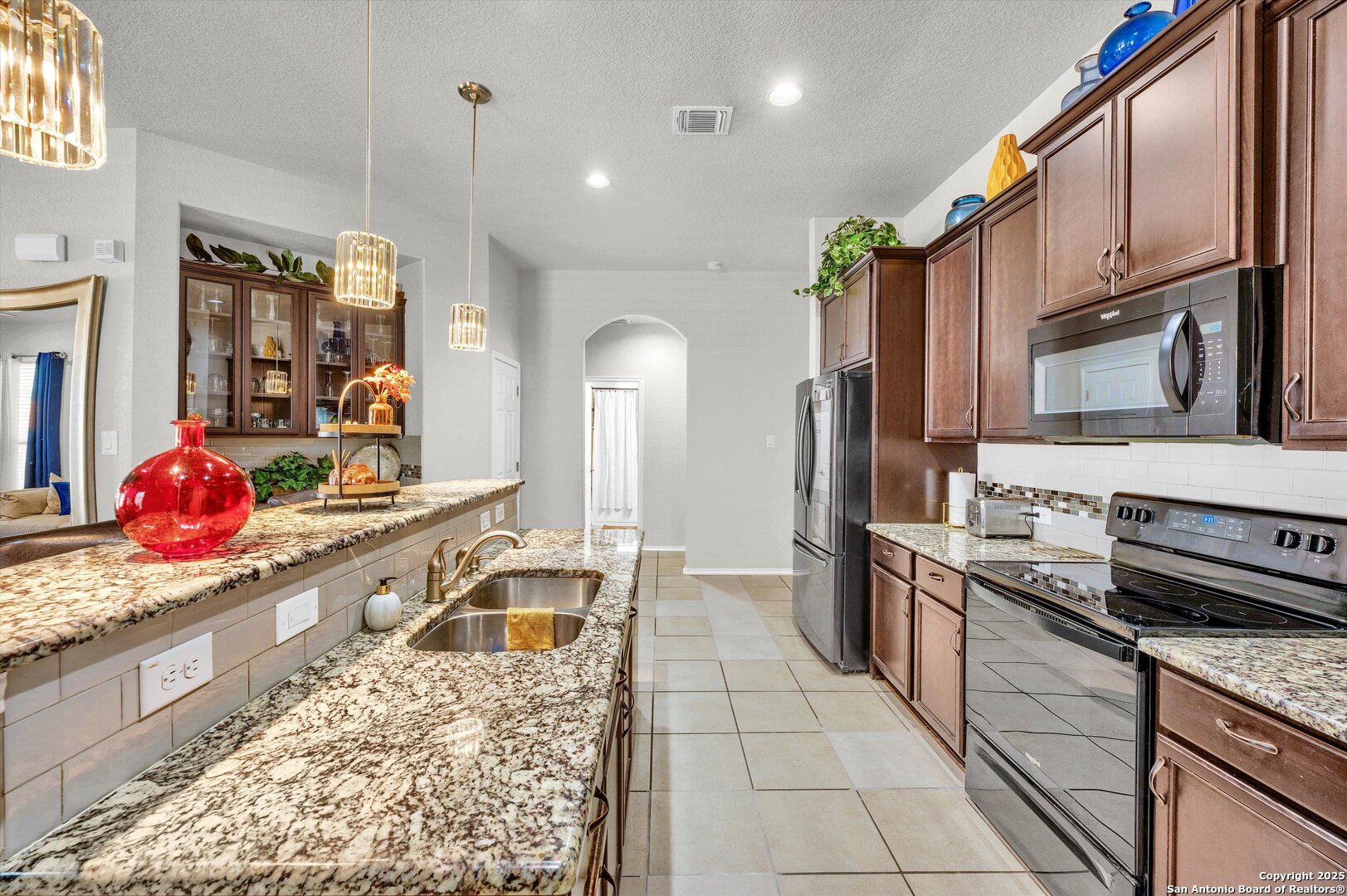 7235 Lunar Eclipse Converse, TX 78109 - Photo 9 of 29 a large kitchen with stainless steel appliances granite countertop a sink and cabinets