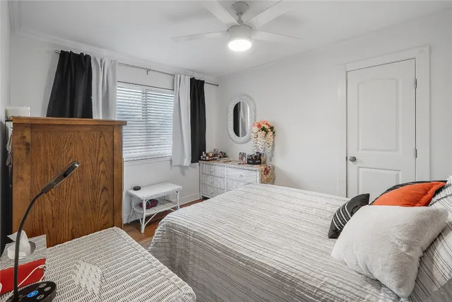 a bedroom with a bed and a mirror