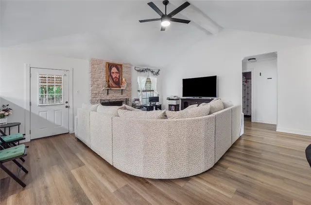 a living room with furniture and a flat screen tv