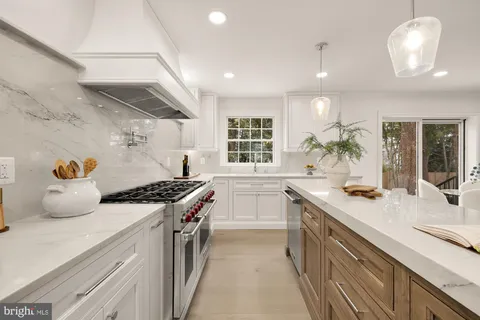 a stove top oven sitting inside of a kitchen