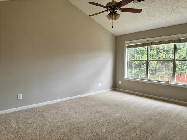 a view of a livingroom with a ceiling fan and window