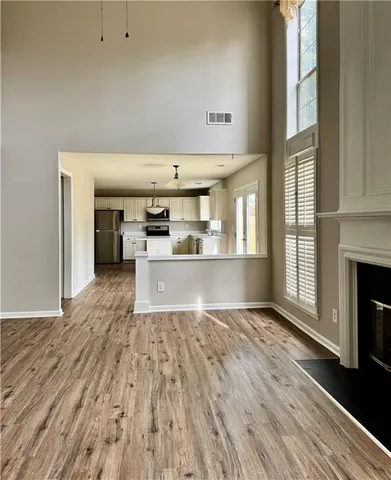 a view of a kitchen with furniture and wooden floor
