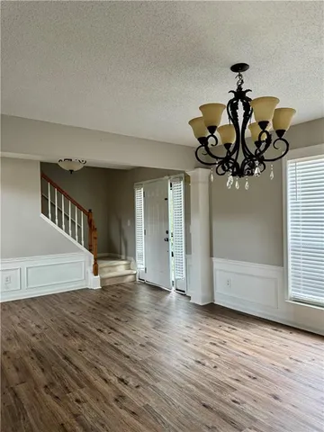 a view of an entryway with wooden floor