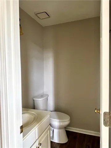 a white toilet sitting next to a bathroom sink