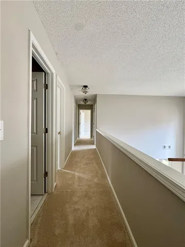 a view of hallway with cabinets