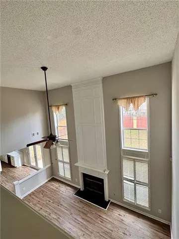 a view of a livingroom with wooden floor and a window