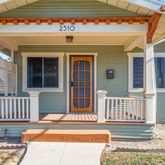 a view of a house with a small deck and wooden floor