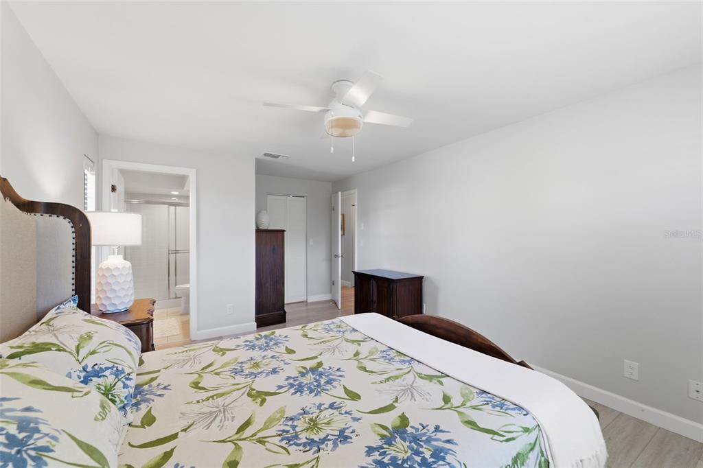 9204 Golf View Drive New Port Richey, FL 34655 - Photo 14 of 39 a bedroom with a bed and a chandelier