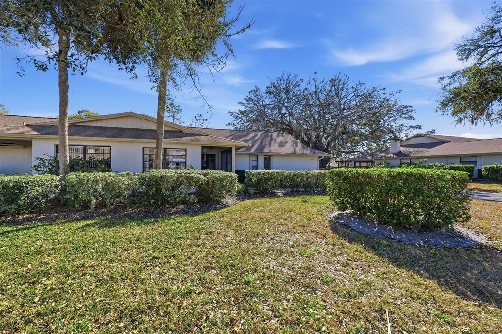 9204 Golf View Drive New Port Richey, FL 34655 - Photo 25 of 39 a front view of a house with a garden