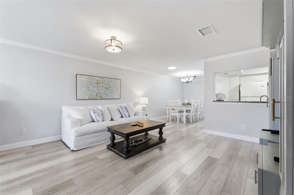 9204 Golf View Drive New Port Richey, FL 34655 - Photo 4 of 39 a living room with furniture and a wooden floor