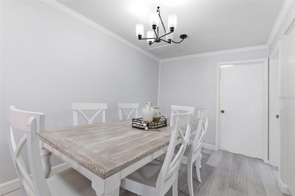 9204 Golf View Drive New Port Richey, FL 34655 - Photo 8 of 39 a dining room with furniture and wooden floor