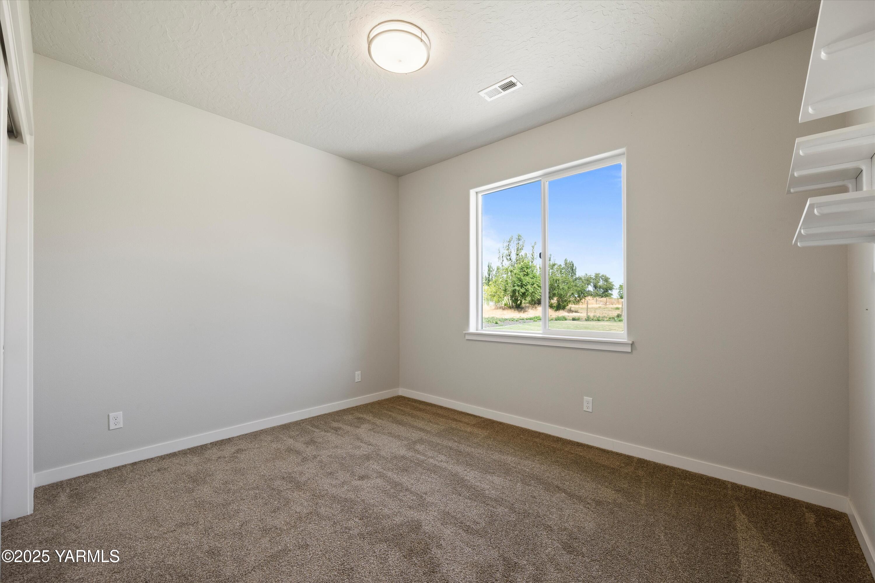 172004 Northwest Dogwood Road Grandview, WA 98930 - Photo 28 of 41 Bedroom on the left side of the home.