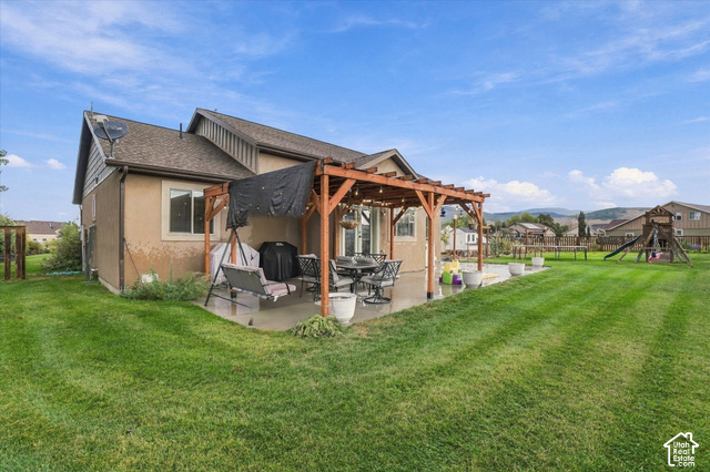 437 Scenic Heights Road Kamas, UT 84036 - Photo 34 of 46 Expansive lawn with a concrete patio, wood pergola, and a large playset