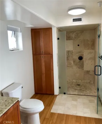 a front view of a building with an outdoor space and sitting area