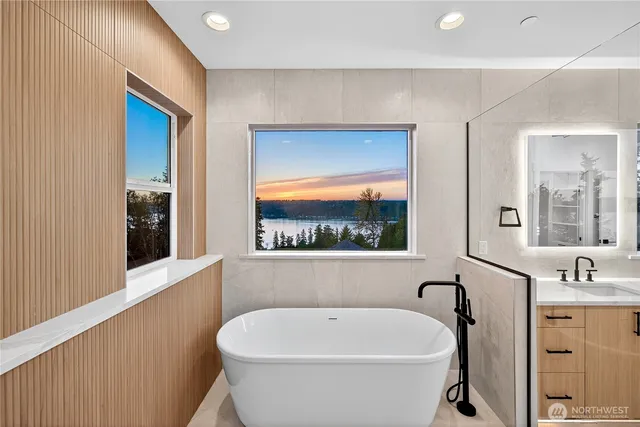 a white bath tub sitting next to a bathroom sink