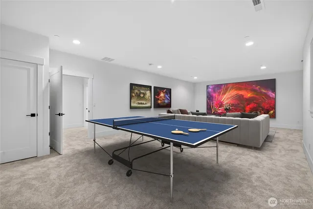 a room with furniture pool table and flat screen tv