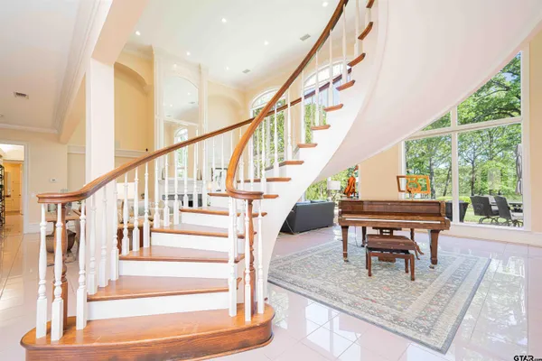 a kitchen with a table chairs stove and white cabinets