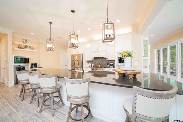 a view of a dining room with furniture large windows and wooden floor