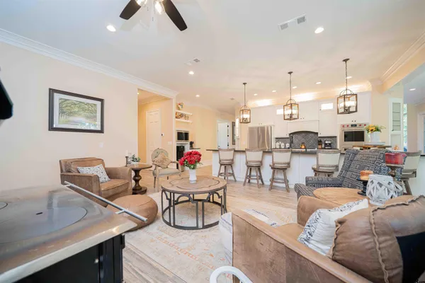 a living room with furniture and a floor to ceiling window