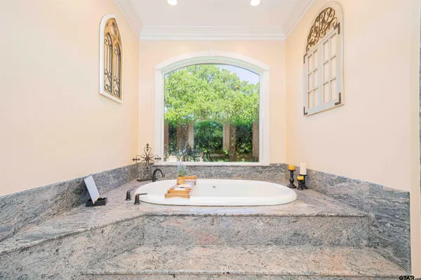 a bathroom with a sink vanity granite tub and shower