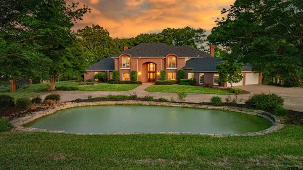 an aerial view of a house with swimming pool outdoor seating and yard