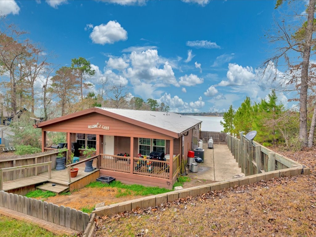 a view of a house with swimming pool and sitting area