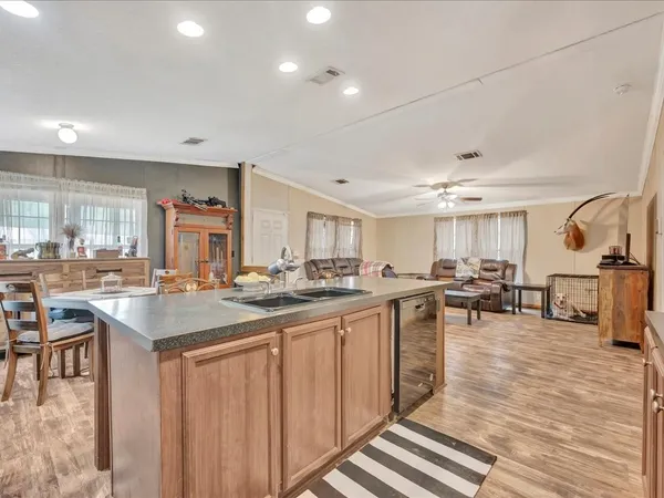 a kitchen with lots of counter top space and painting on the wall