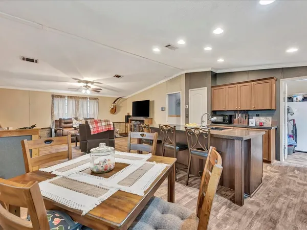 a living room with lots of furniture and kitchen view