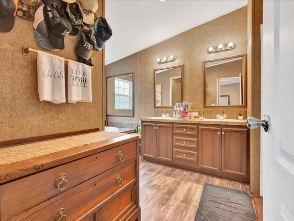 a bathroom with a sink a vanity and a mirror