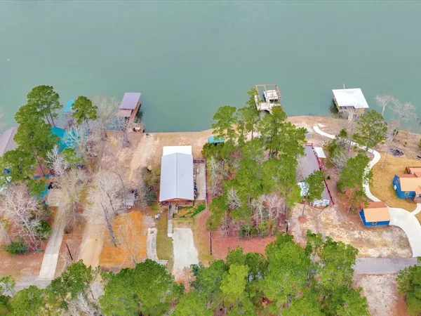 an aerial view of a house with a yard and garden