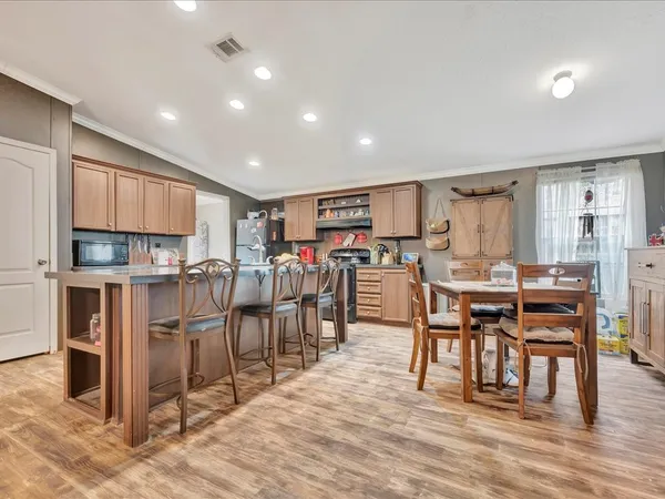 a view of a dining area with furniture and a kitchen