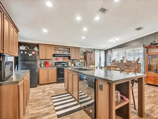 a kitchen with stainless steel appliances granite countertop a sink counter space cabinets and a counter top space