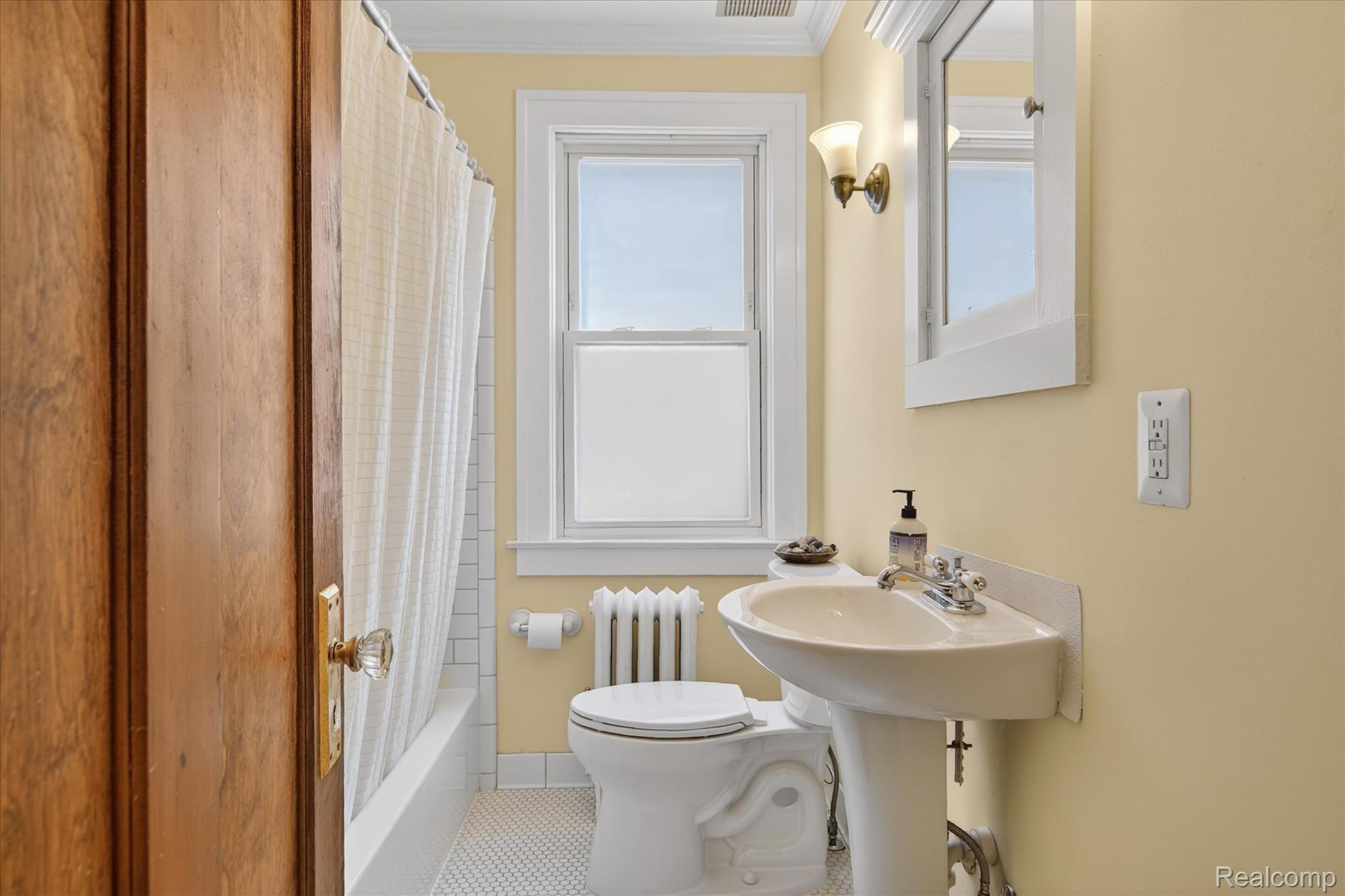 925 Nottingham Road Grosse Pointe, MI 48230 - Photo 33 of 46 Bathroom with shower / bath combo with shower curtain, radiator, tile patterned floors, and ornamental molding