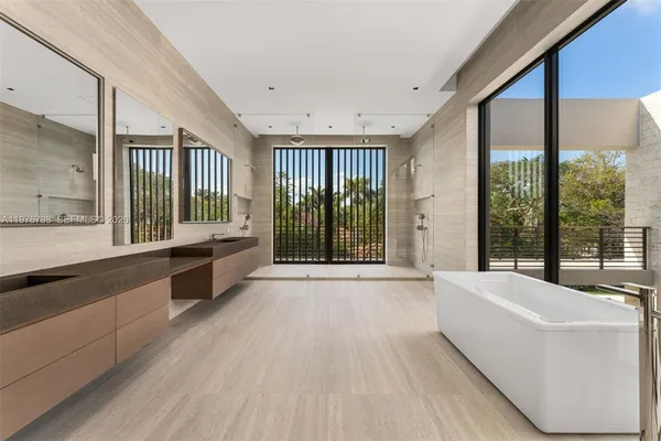 a bathroom with a bathtub and windows