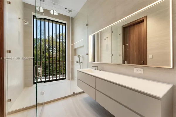 a bathroom with a tub sink and mirror