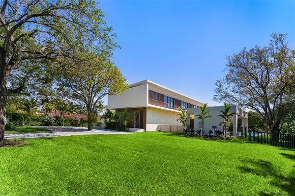 a front view of house with yard and green space