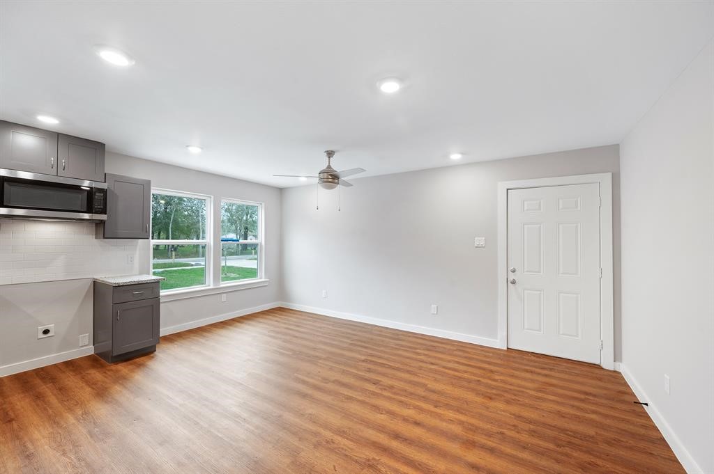 7804 Crestview Drive, Unit B Houston, TX 77028 - Photo 4 of 23 a view of an empty room with wooden floor and a window