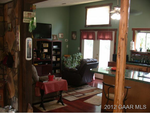 792 Stribling Springs Road Mount Solon, VA 22843 - Photo 3 of 9 a living room with furniture a flat screen tv and a floor to ceiling window