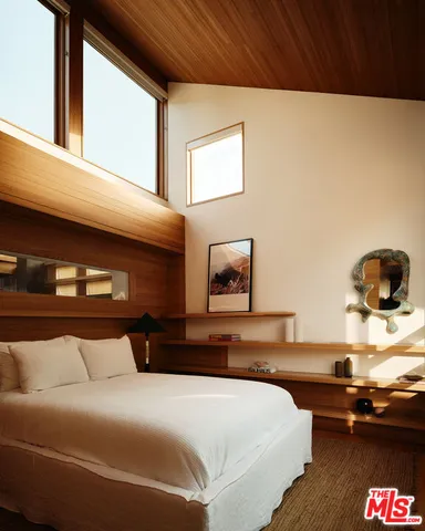 a bedroom with a bed and dresser