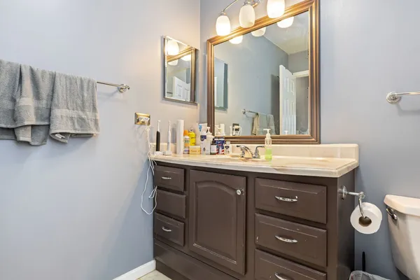 a bathroom with a sink vanity and mirror