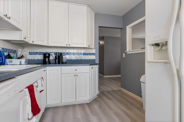 a kitchen with stainless steel appliances granite countertop a refrigerator and cabinets