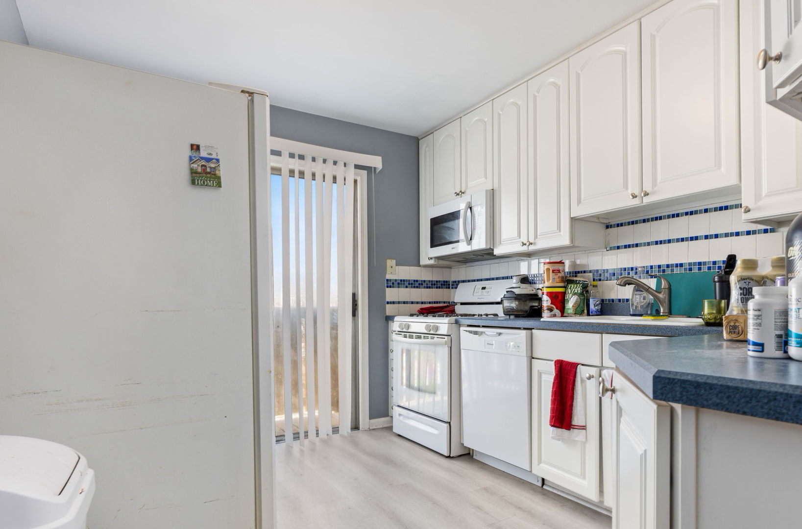 1055 Hampton Harbor, Unit 1055 Schaumburg, IL 60193 - Photo 4 of 14 a kitchen with stainless steel appliances a white refrigerator a sink and cabinets