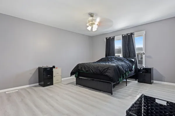 a bedroom with a bed and a chandelier