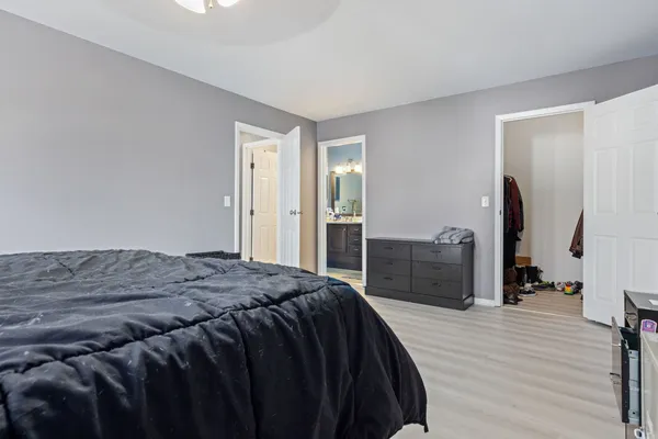 a bedroom with a bed and a walk in closet