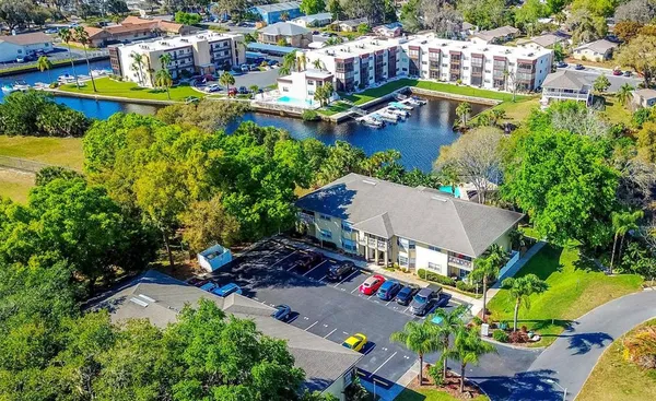 an aerial view of a house with a garden and lake view